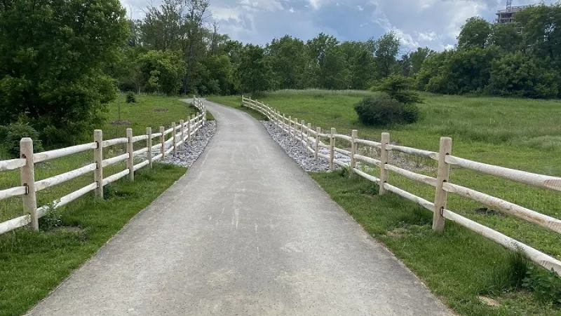 Picture of trail in the middle of a field with fencing