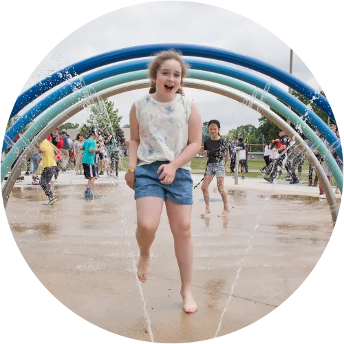 Child playing in a City operated splashpad.