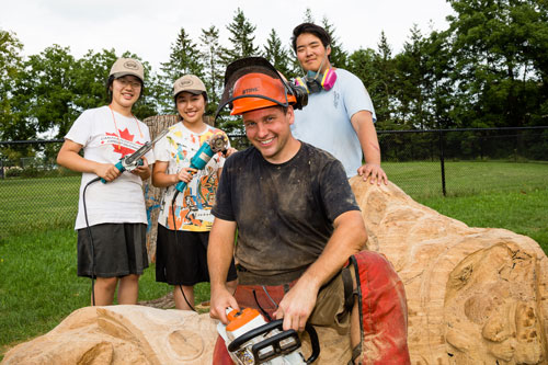 Shane Clodd with three Unionville High School students at the Markham Museum grounds.